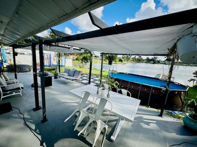 view of patio featuring a water view and an outdoor hangout area