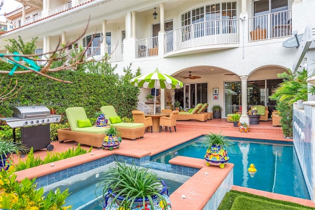 view of pool featuring a hot tub, a grill, ceiling fan, and a patio