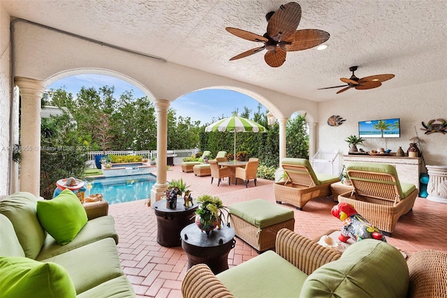 view of patio / terrace with ceiling fan, an outdoor hangout area, and a fenced in pool