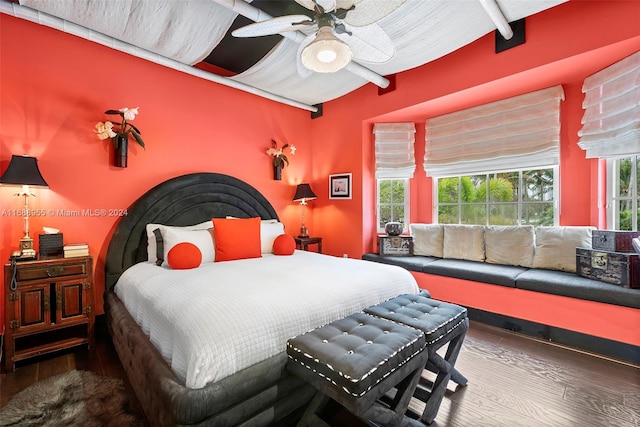 bedroom with multiple windows, hardwood / wood-style flooring, and ceiling fan