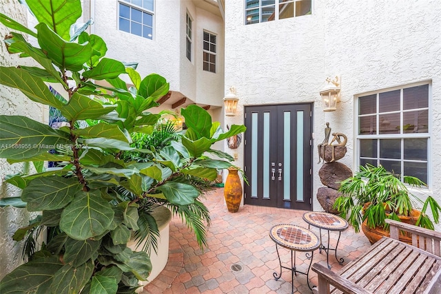 entrance to property featuring a patio