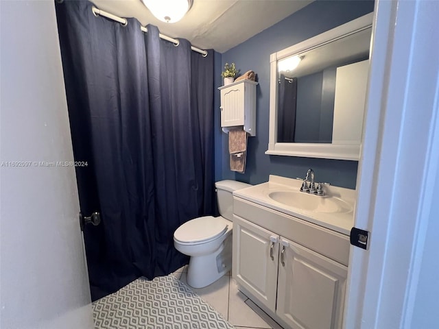 bathroom with vanity, tile patterned floors, and toilet