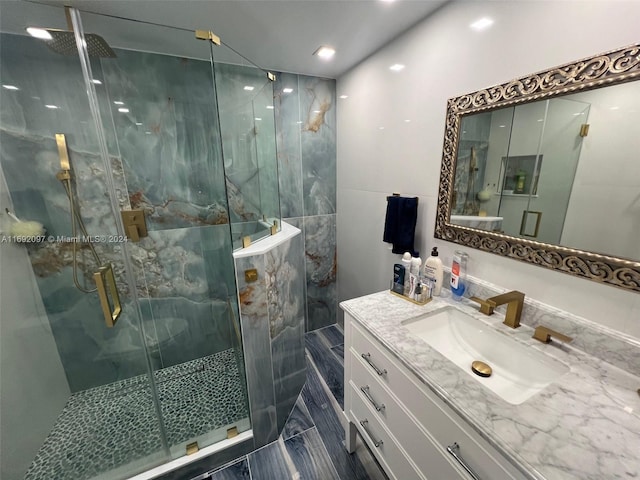 bathroom featuring vanity and an enclosed shower