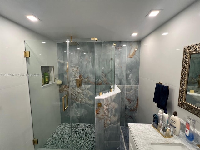 bathroom with walk in shower and vanity