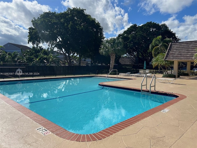 view of swimming pool with a patio and a gazebo