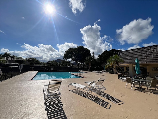 view of swimming pool with a patio area