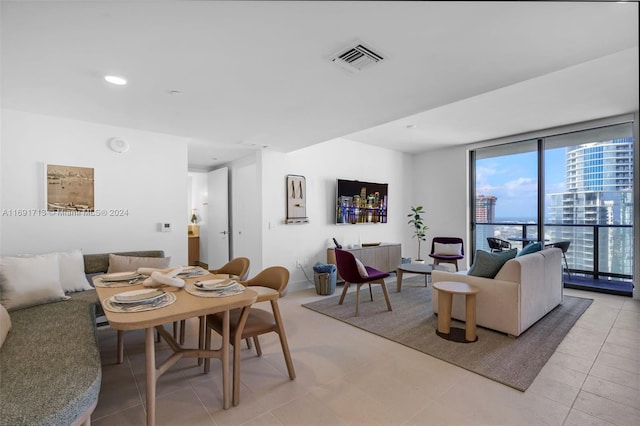 tiled living room featuring floor to ceiling windows