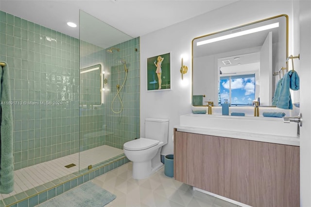 bathroom featuring vanity, toilet, and a tile shower