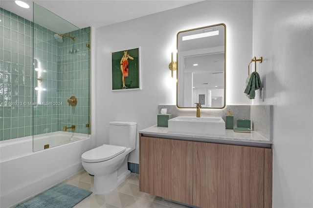 full bathroom with vanity, tiled shower / bath combo, and toilet