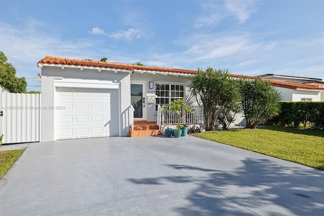 view of front of home featuring a garage and a front yard