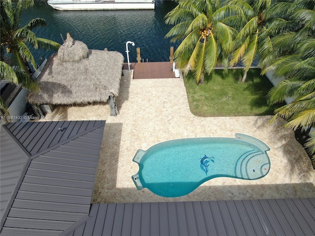 view of swimming pool featuring a water view