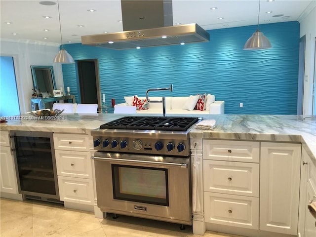 kitchen featuring hanging light fixtures, white cabinetry, high end stainless steel range oven, and beverage cooler