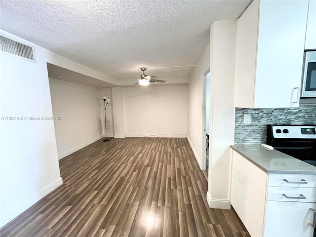 interior space featuring a textured ceiling, dark hardwood / wood-style floors, and ceiling fan