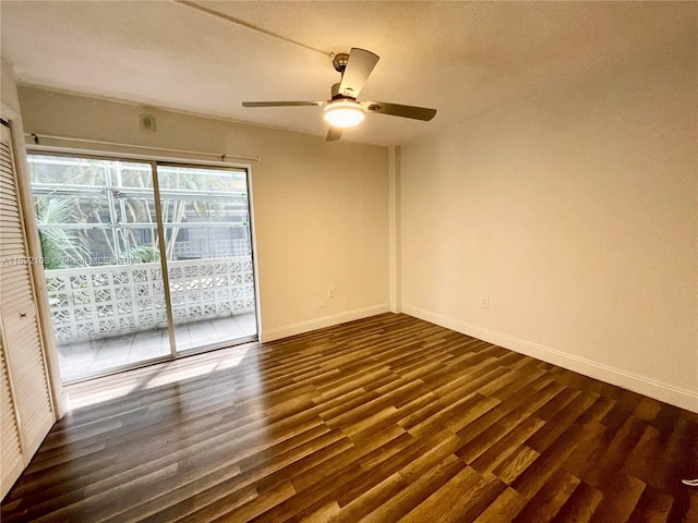 unfurnished room featuring dark wood-type flooring and ceiling fan