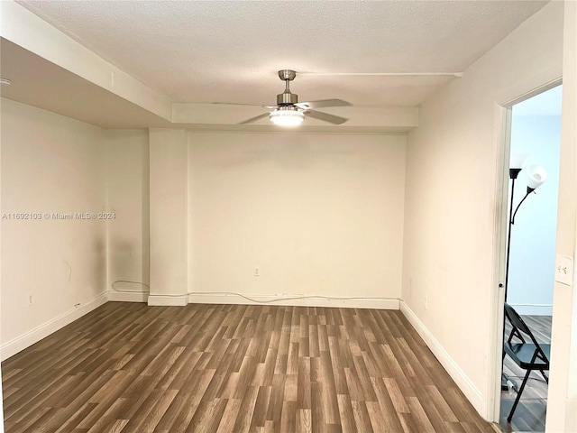 unfurnished room featuring a textured ceiling, dark hardwood / wood-style floors, and ceiling fan