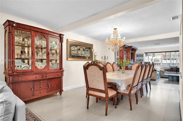 dining area featuring a textured ceiling, a notable chandelier, and light tile patterned floors