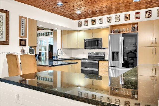 kitchen with dark stone counters, appliances with stainless steel finishes, wood ceiling, sink, and kitchen peninsula