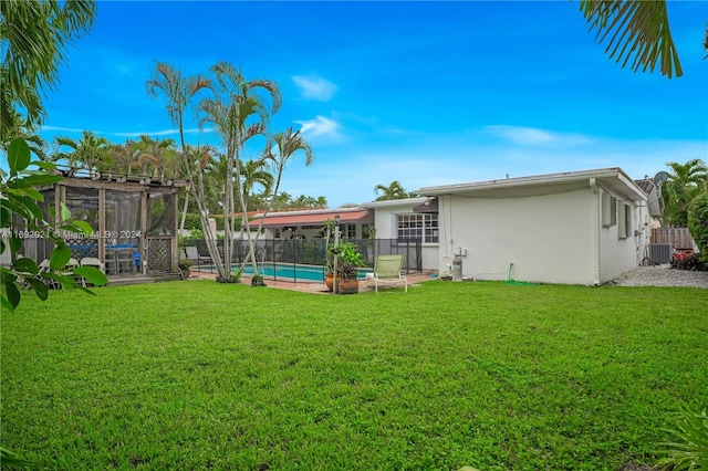 view of yard featuring a fenced in pool and central AC unit