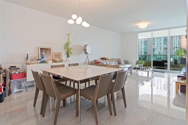 dining space featuring a wall of windows