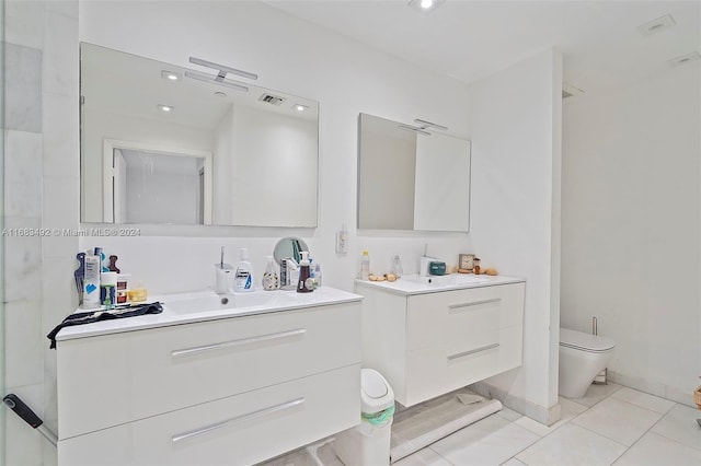 bathroom featuring toilet, vanity, and tile patterned flooring