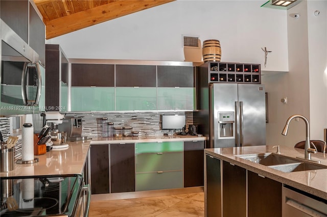 kitchen with lofted ceiling with beams, backsplash, appliances with stainless steel finishes, sink, and wooden ceiling