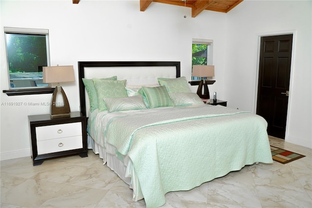 bedroom featuring vaulted ceiling with beams