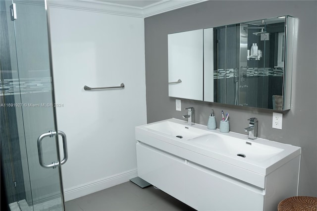 bathroom with an enclosed shower, vanity, tile patterned floors, and crown molding