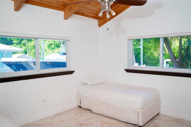 living area with a wealth of natural light, ceiling fan, wood ceiling, and lofted ceiling with beams