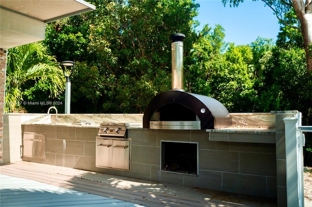 exterior space featuring a grill and exterior kitchen