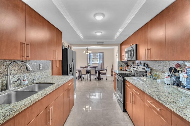 kitchen with stainless steel appliances, light stone countertops, sink, and a raised ceiling