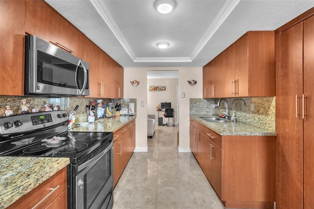 kitchen featuring light stone countertops, appliances with stainless steel finishes, sink, and backsplash