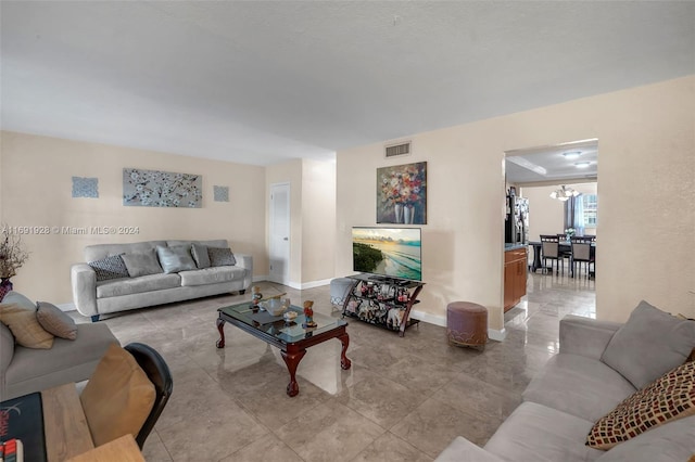 living room featuring a notable chandelier