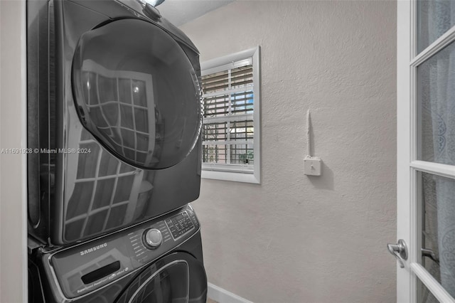 laundry room featuring stacked washer and dryer