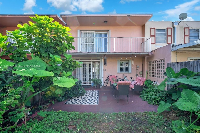 rear view of house with a balcony and a patio area