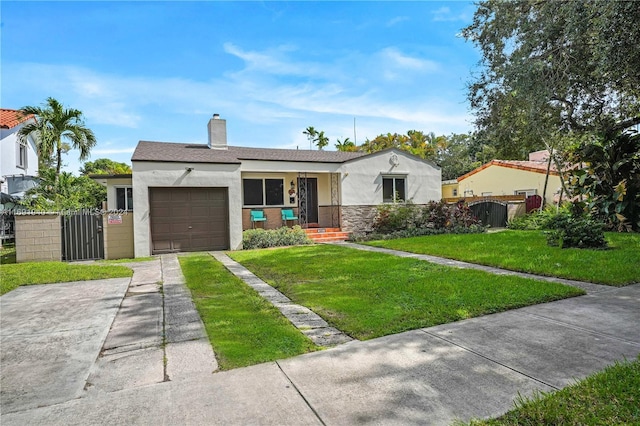 view of front of property with a front yard and a garage