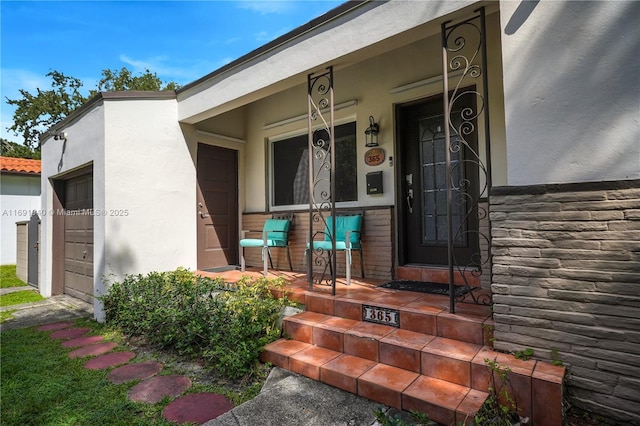 view of exterior entry featuring a porch