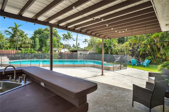 view of swimming pool with sink and a patio area