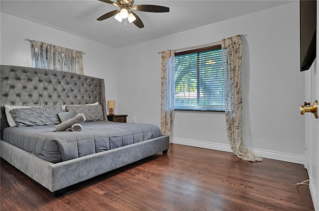 bedroom with ceiling fan and dark wood-type flooring