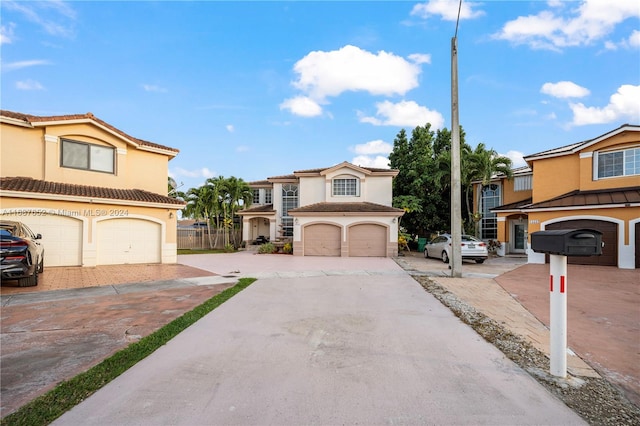 mediterranean / spanish-style home with a garage