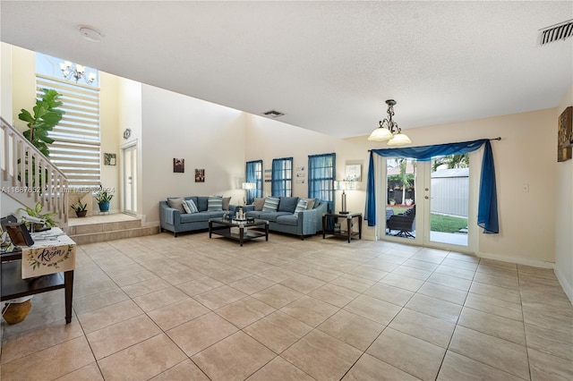 living room featuring a textured ceiling and light tile patterned floors