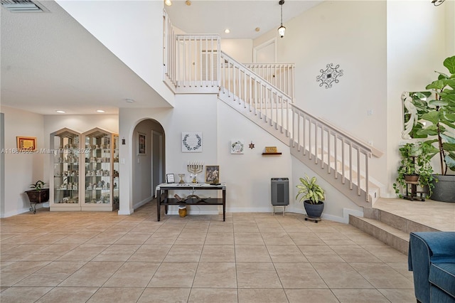 interior space with tile patterned flooring and a high ceiling