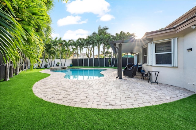 view of swimming pool featuring ceiling fan, a yard, and a patio area