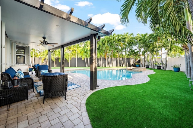 view of swimming pool featuring a patio, a lawn, ceiling fan, and an outdoor living space