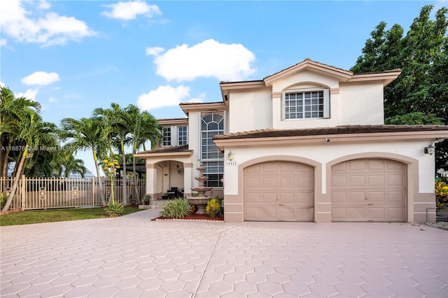 mediterranean / spanish home featuring a garage