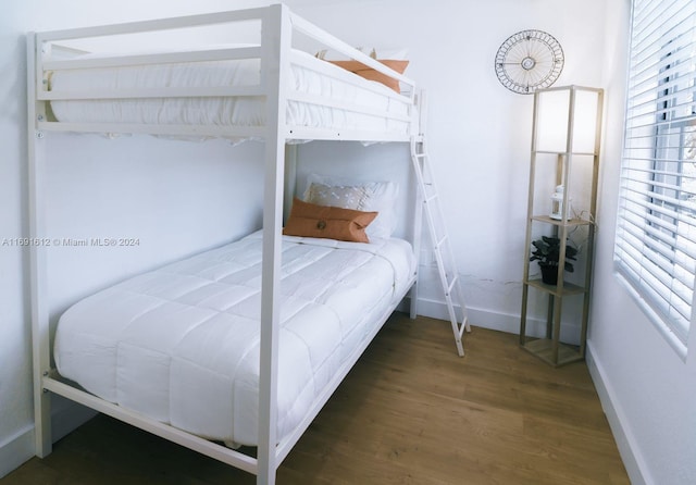 bedroom with dark hardwood / wood-style flooring