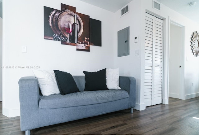 living room with electric panel and dark hardwood / wood-style floors