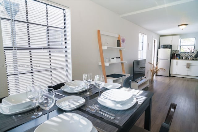 dining area featuring dark wood-type flooring