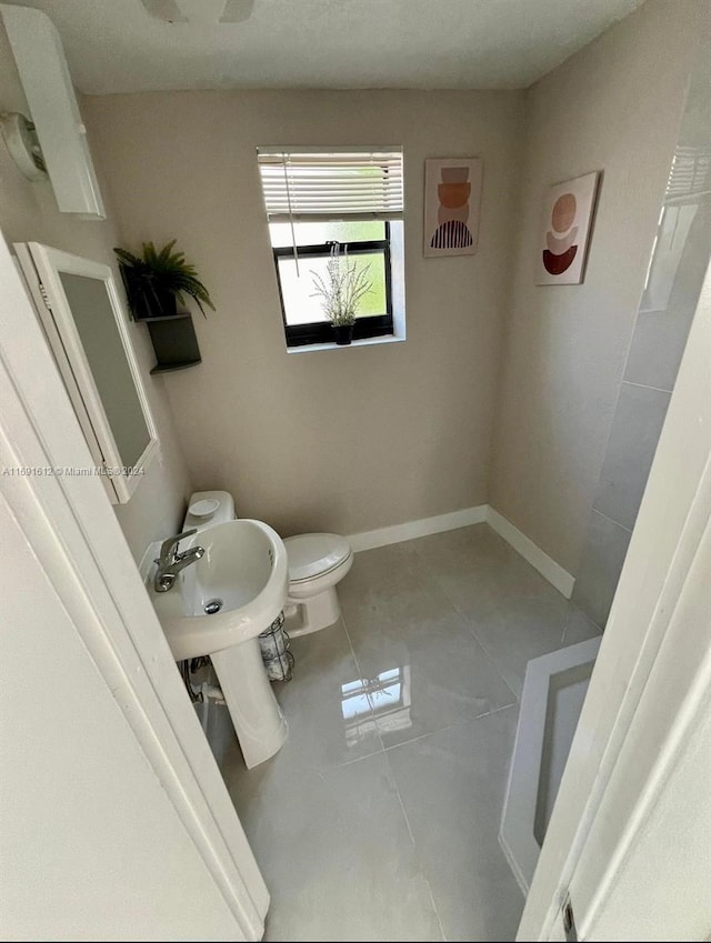 bathroom with tile patterned floors and toilet