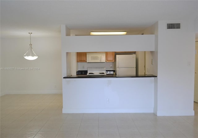 kitchen featuring pendant lighting, white appliances, and light tile patterned flooring