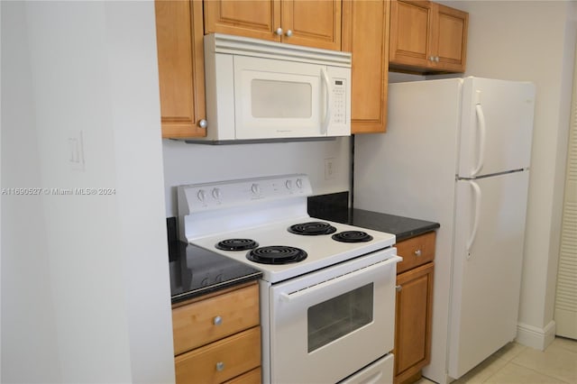 kitchen featuring white appliances and light tile patterned floors